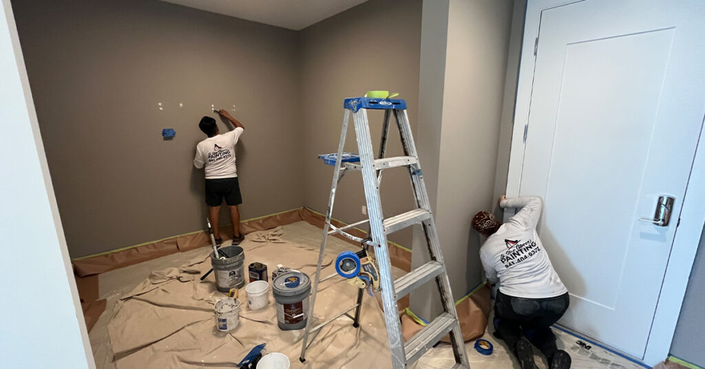 A Step Above Painting crew prepping and repainting a home in Sarasota, Florida