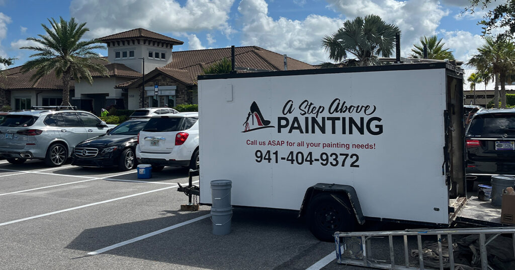 A Step Above Painting company trailer at a commercial painting job site in Sarasota, Florida