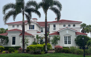 Freshly repainted two-story home with palm trees in Sarasota, Florida