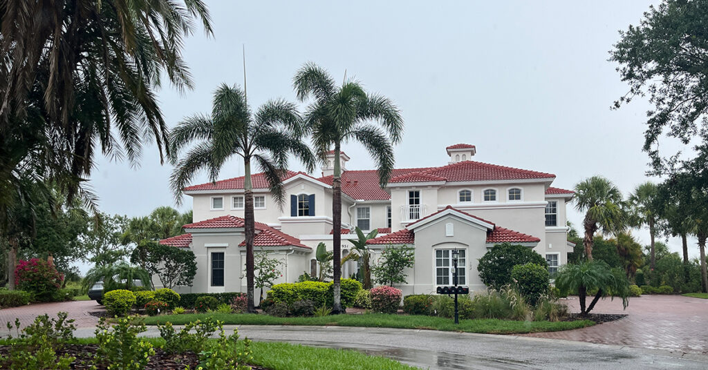 Newly painted Mediterranean stucco home with red tile roof in Sarasota, Florida