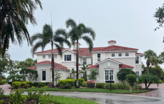 Newly painted Mediterranean stucco home with red tile roof in Sarasota, Florida